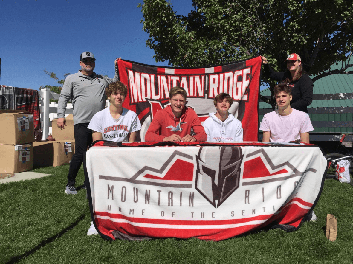 Mountain Ridge staff and students at the campaign distribution event, with two of the original blanket designs on display